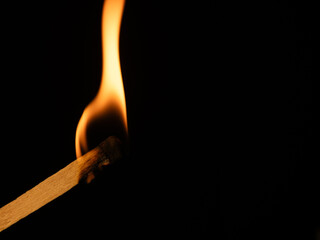 burning match on black background with one burning with white flame