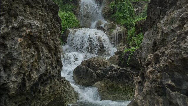 Bantul, December 3, 2022. Timelapse of Parang Endok Beach waterfall in the morning. the flow of this waterfall water directly to parangtitis beach