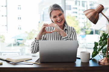 Laptop, heart sign and mature woman in office for virtual meeting, communication or networking....