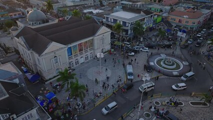 Aerial view of Montego Bay Cultural Centre, in the lively Sam Sharpe Square square, featuring historic buildings, bustling street life, and urban scenery at dusk