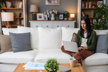 Career winner mindset. Young freelance businesswoman working at home. Confident dedicated female learning and educate herself for better opportunity in her business career, work on laptop computer.