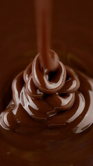 Pouring melted dark chocolate, close up. Liquid hot chocolate. Confectioner prepares chocolate dessert, glaze