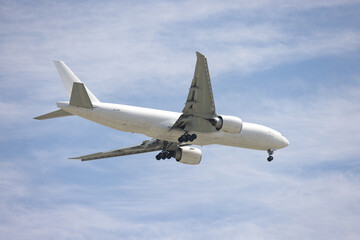 Airplane flying against a blue sky.