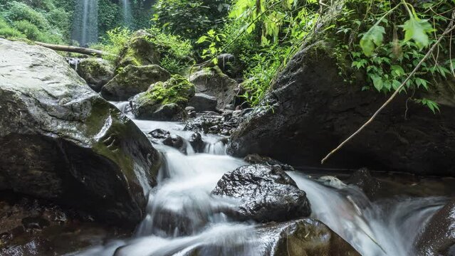 timelapse the beauty of the twin grenjengan waterfalls in the morning. The twin grenjengan waterfalls are located in Pakis District, Magelang, Central Java.