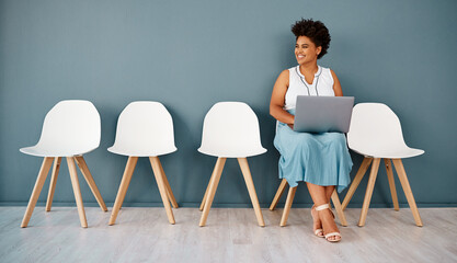 Woman, waiting room with laptop and wall background, interview or smile for appointment. Hiring,...
