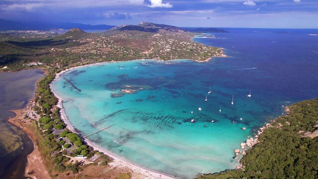 Best beaches of Corsica island - aerial drone video of beautiful Santa Giulia long beach with sault lake from one side and turquoise sea from other
