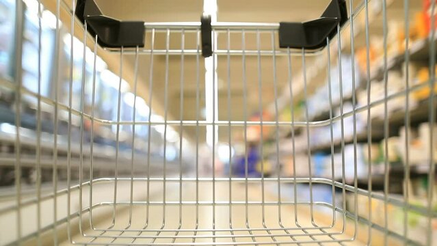 Shopping cart moving through supermarket