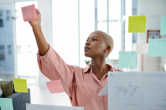 Glass, problem solving and sticky notes with business black woman in office for brainstorming or planning. Agenda, moodboard and schedule with employee in workplace for development of company vision