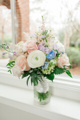 Lovely wedding reception bouquet on a window sill