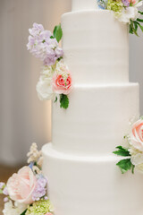 Elegant white wedding cake adorned with flowers