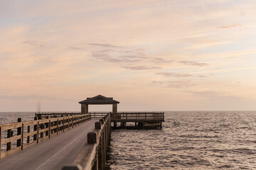 Fototapeta premium Sunset view of a dock over water in Fairhope, Alabama