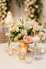 Centerpiece with white and pink flowers and multiple candles