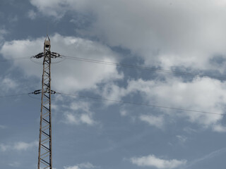 Aged Power Mast Standing Tall, Symbolizing Industrial History and Technological Progress