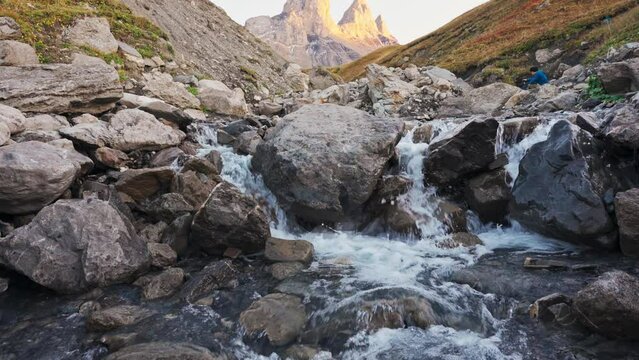 Landscape of Iconic mountain peak of Aiguilles d Arves with waterfall flowing in French Alps at Savoie, France