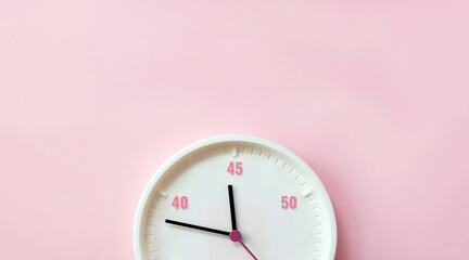 Numbers 40, 45 and 50 years and white clock dial on pink background. Age and periods of menopause. Selective focus, copy space