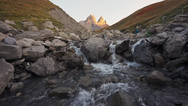 Landscape of Iconic mountain peak of Aiguilles d Arves with waterfall flowing in French Alps at Savoie, France