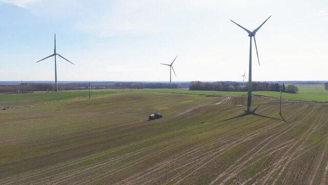 Drone footage of wind generators working in a wind farm in a green field in Taurage, Lithuania