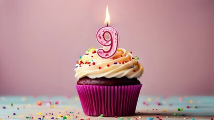 Birthday cupcake with lit birthday candle. Number nine for nine years or ninth anniversary.