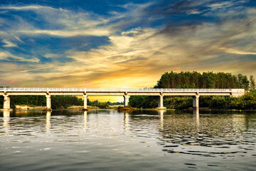 Fototapeta premium View of a bridge passing over the river Sutlej at Sunset time in rural Punjab, India.