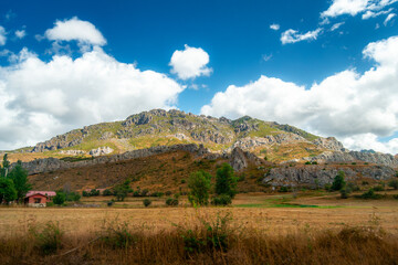 Scenic view of Asturias, Spain's rocky mountains on a cloudy day with vibrant colors