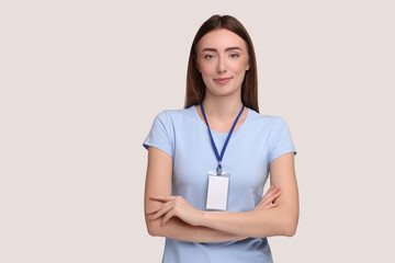 Woman with blank badge on grey background