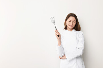 Professional chef with whisk on light background. Space for text