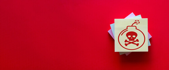 Yellow sticky note with bomb and skull icons on a red background,  use for warning signs, security notices, and hazard communications, underscoring the significance of risk awareness and protection.