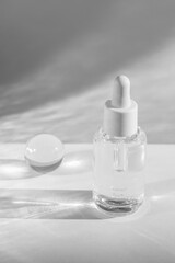 clear serum bottle with crystal ball and shadows