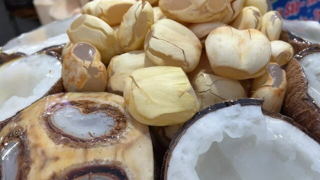 Fresh green coconuts on display at a tropical market, with a focus on natural, organic produce during the night