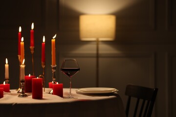 Elegant table setting with burning candles in restaurant
