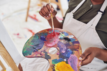 Person, hands and art with palette in closeup for painting on canvas for creative expression and...