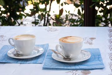 Two Cappuccinos on Outdoor Cafe Table
