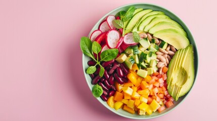 A vibrant bowl brimming with colorful vegetables, beans, and fresh avocado slices, set against a pastel pink background, creating a visually appealing and healthy meal presentation