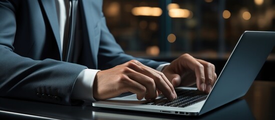 business man typing on laptop keyboard