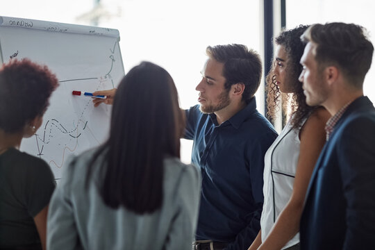 Group, people and kpi with chart, presentation in meeting, discussion or debrief in office. Collaboration, career and project management team in company, business or corporate for feedback or results