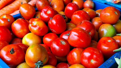 Fresh tomatoes displayed and sold at a traditional market.