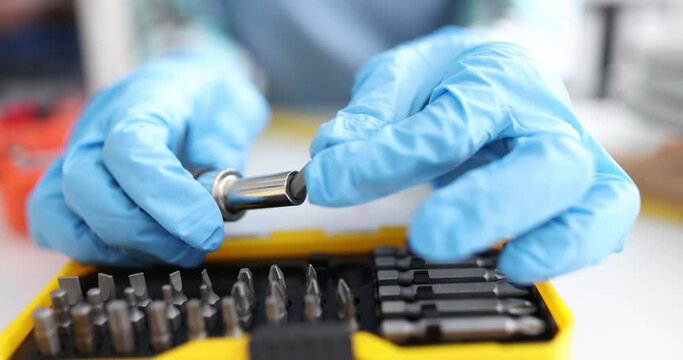 Interchangeable set of screwdrivers with heads and nozzles made of various types of steel. Macro shot of set of screwdrivers with interchangeable screwdriver