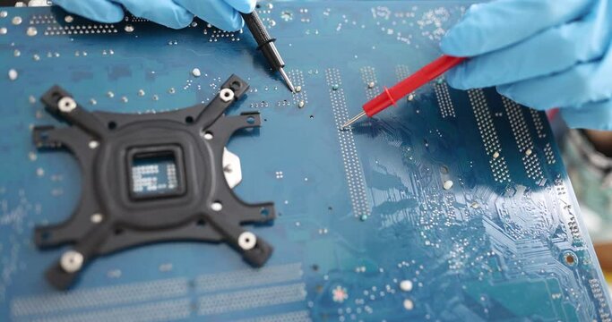 Electronics technician is testing computer chip. PC repair concept