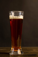dark beer in a glass glass, fresh dark alcoholic beer