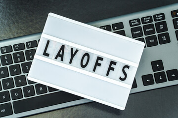 Computer keyboard and lamp with text layoffs