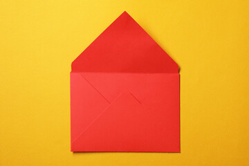 Red letter envelope on orange background, top view