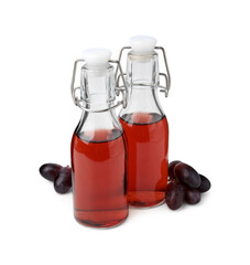 Bottles with wine vinegar and grapes isolated on white