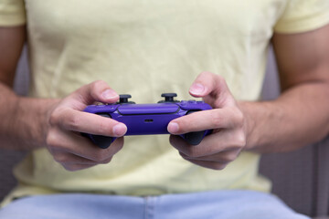 Man plays video games. Close-up of male hands holds joystick. Leisure time and gamer concept	