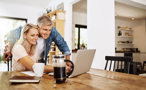 Mature, couple and retirement research on laptop planning finance, real estate or reading news online. Banking, investment and people with talking of asset management in home with document or review