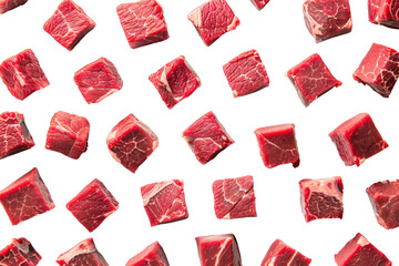Raw beef meat cubes scattered across a white surface, like dice on a game board, isolated on white background