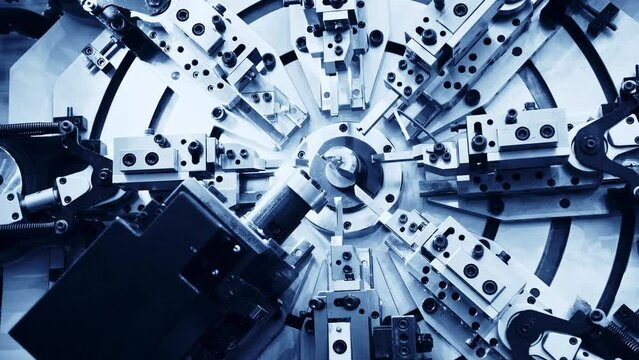 Close up of metal spring manufacturing machine at work