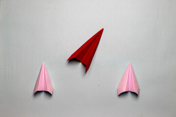 Business concept red plane with white paper planes on a light grey background motivation aviation...
