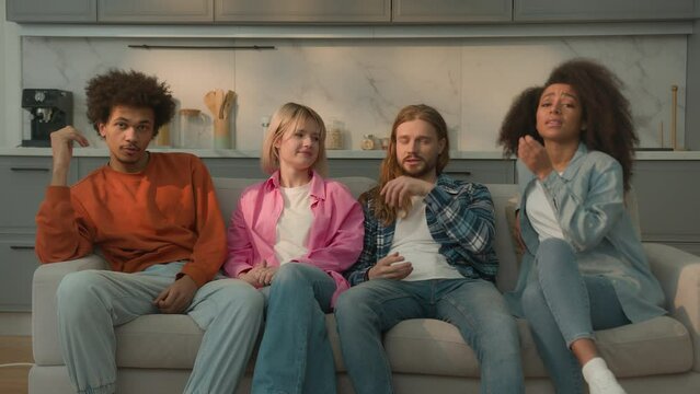 Multiracial people multiethnic friends diversity students Caucasian women female girls African American men male guys together home couch sofa watching boring TV show movie bad film bored talking yawn