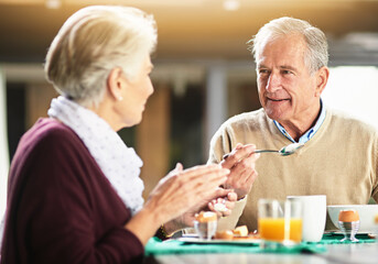 Happy, senior couple and eating breakfast together with conversation about retirement and marriage...
