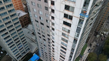 This captivating drone photo shows skilled workers performing maintenance tasks on a scaffold at a...
